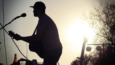 Derek Colby playing at sunset